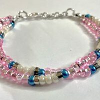 Double Strand Pink 6/0 seed bead bracelet with blue, white pearlescent, and metal accents