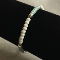 Light translucent green and opaque white 6/0 seed beads with metal accent