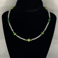 Large green glass beads with silver 6/0 beads and metal accent beads