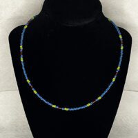 Blue 8/0 glass seed bead with red and green accent beads